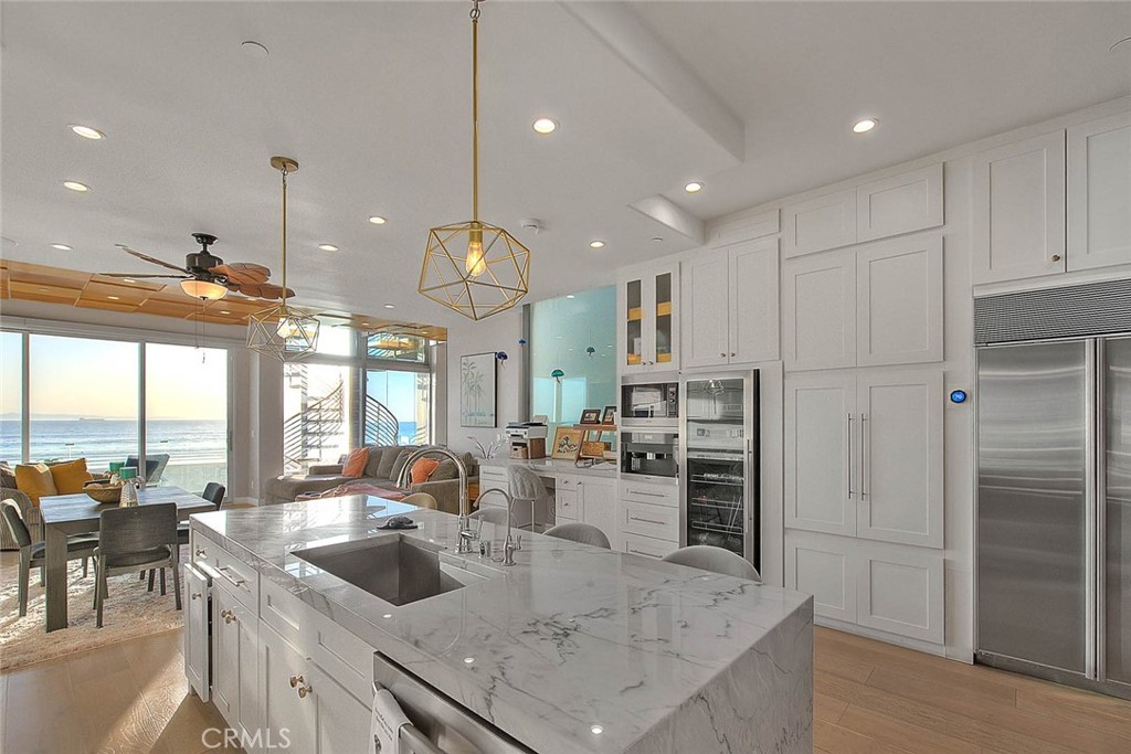 99 A Surfside Avenue Surfside, CA 90743 - Photo 19 of 75 a kitchen with a refrigerator a sink and a stove