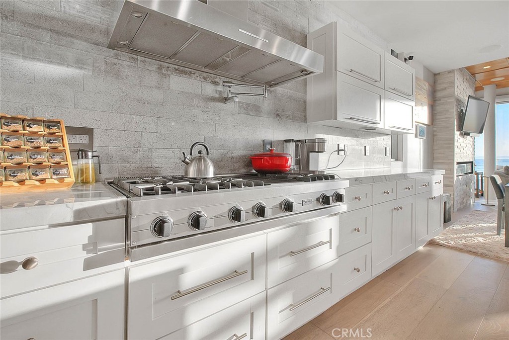 99 A Surfside Avenue Surfside, CA 90743 - Photo 21 of 75 a kitchen with stainless steel appliances granite countertop a sink and cabinets