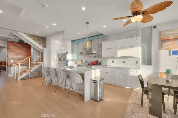 a living room with stainless steel appliances granite countertop furniture and a kitchen view