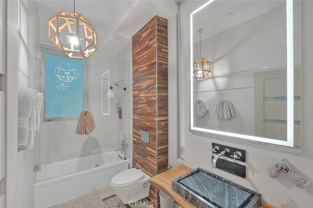 99 A Surfside Avenue Surfside, CA 90743 - Photo 29 of 75 a bathroom with a toilet a sink and a shower