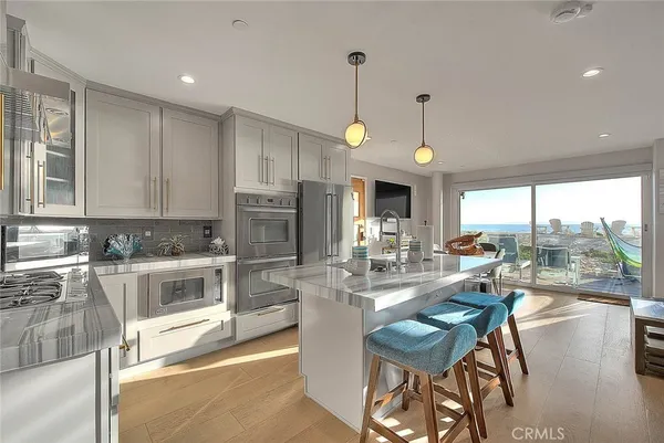 a kitchen with stainless steel appliances kitchen island granite countertop a sink and cabinets
