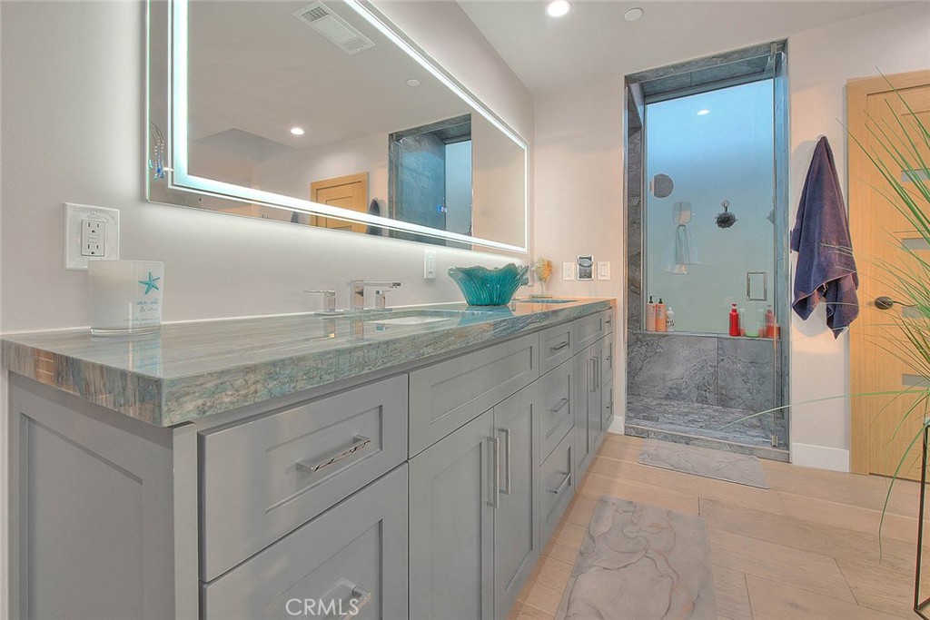 99 A Surfside Avenue Surfside, CA 90743 - Photo 39 of 75 a bathroom with a sink and a mirror