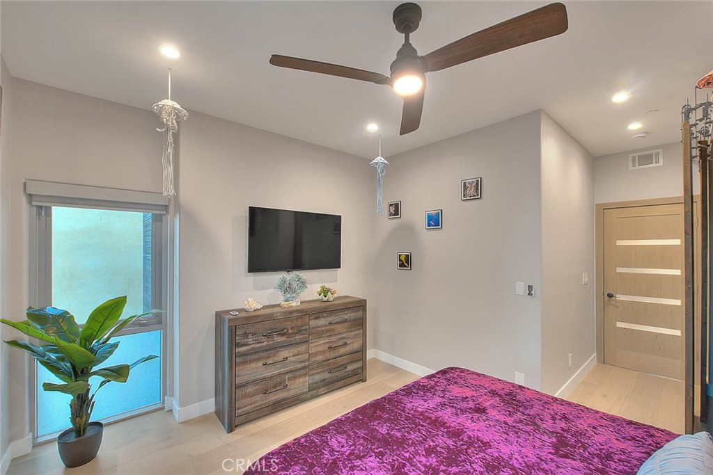 99 A Surfside Avenue Surfside, CA 90743 - Photo 47 of 75 a bedroom with a bed and a flat screen tv