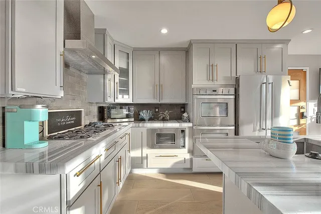 a kitchen with a stove a sink and a refrigerator