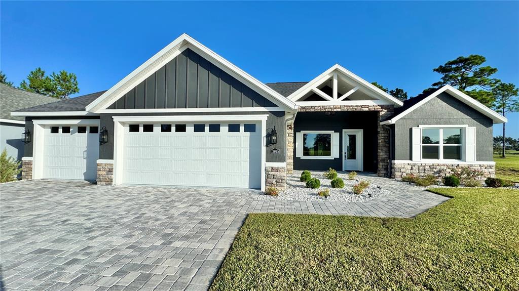 17665 Southwest 61st Ln Road Dunnellon, FL 34432 - Photo 1 of 32 a front view of a house with garden