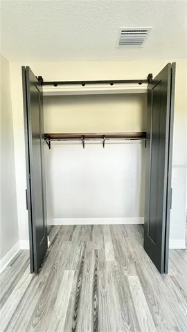 an empty room with wooden floor and a window