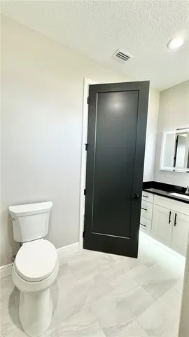 a bathroom with a toilet and a sink