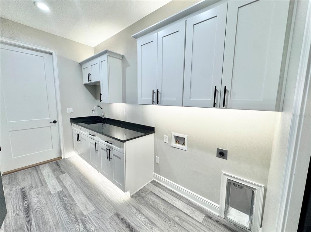 17665 Southwest 61st Ln Road Dunnellon, FL 34432 - Photo 22 of 32 a kitchen with white cabinets and white appliances