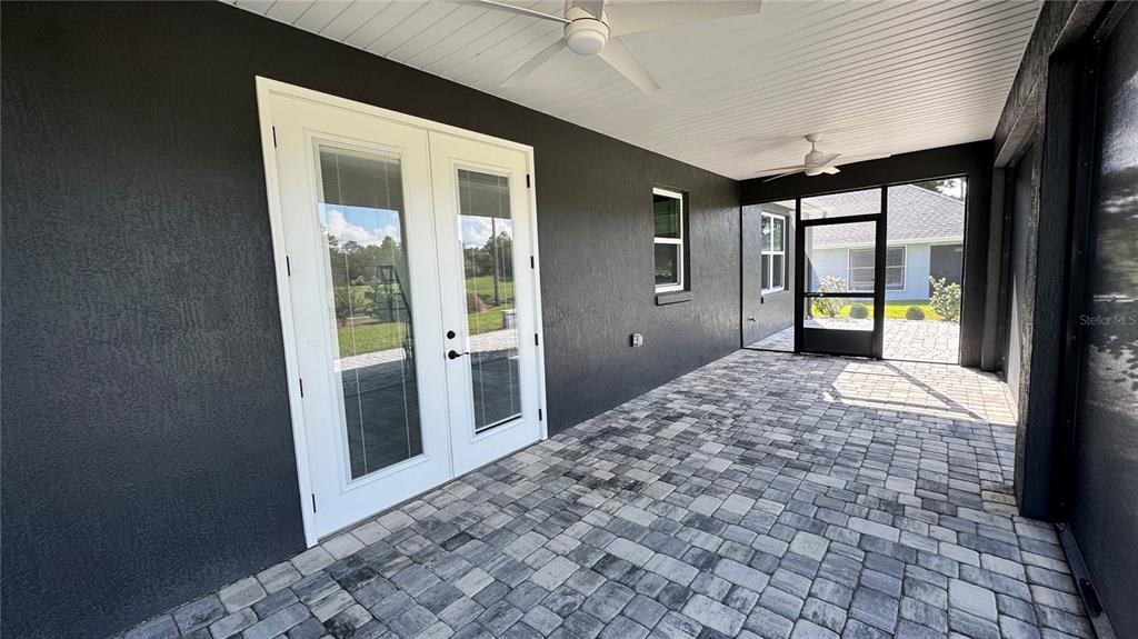 17665 Southwest 61st Ln Road Dunnellon, FL 34432 - Photo 24 of 32 a bedroom with a bed and glass door