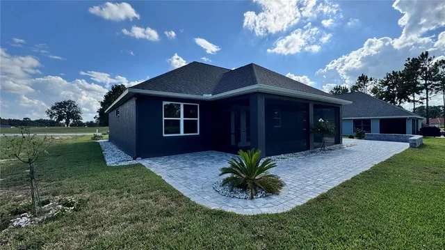 a view of a house with a yard and a garden