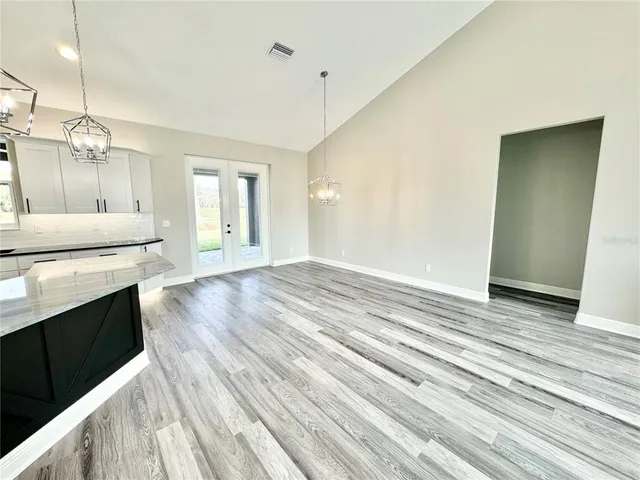 a view of a kitchen with wooden floor and a sink