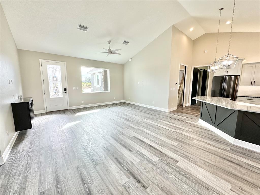17665 Southwest 61st Ln Road Dunnellon, FL 34432 - Photo 7 of 32 a view of a kitchen with kitchen island wooden floor center island and windows