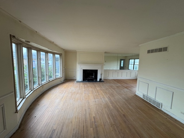8135 West Rascher Avenue Chicago, IL 60656 - Photo 2 of 11 a view of empty room with wooden floor and fireplace