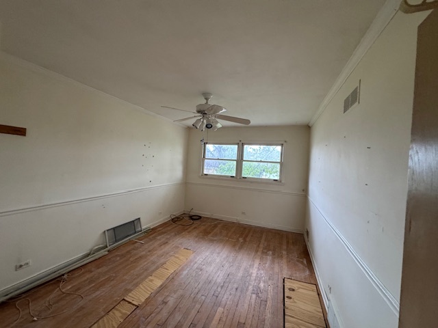 8135 West Rascher Avenue Chicago, IL 60656 - Photo 6 of 11 an empty room with wooden floor fan and windows