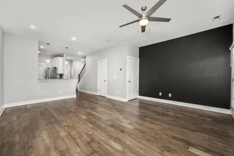 a view of a kitchen and an empty room