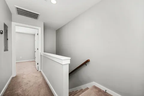 an empty room with a ceiling fan and a window