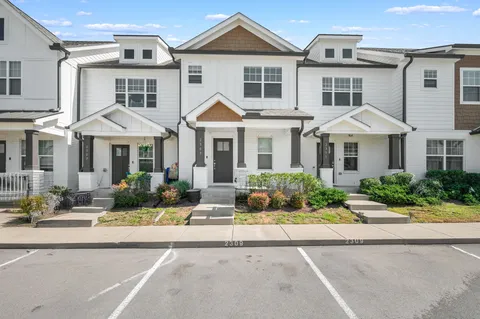 a front view of a residential houses with yard