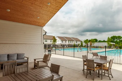 a view of a house with swimming pool and sitting area