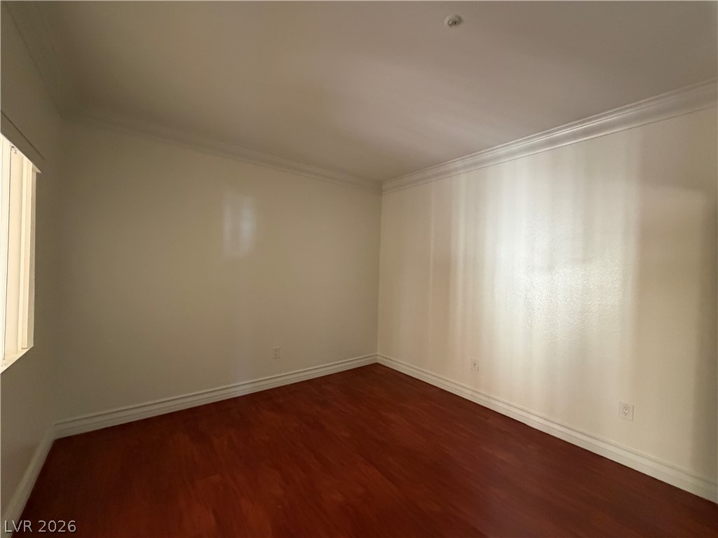210 East Flamingo Road, Unit 126 Las Vegas, NV 89169 - Photo 13 of 16 Rich hardwood flooring complements a neutral palette and crown molding in this adaptable space.