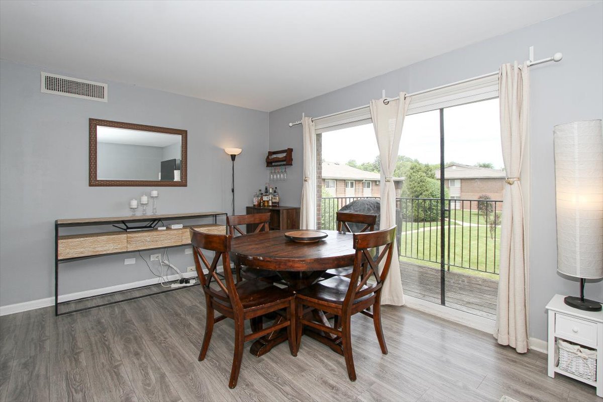 2300 Old Tavern Road, Unit 203 Lisle, IL 60532 - Photo 10 of 26 a view of a dining room with furniture window and wooden floor