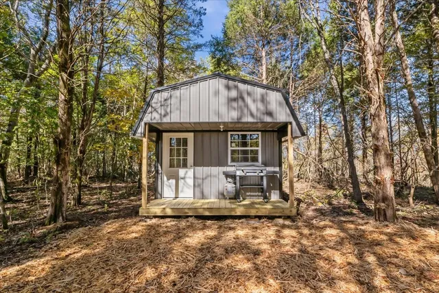 a backyard of a house with table and chairs