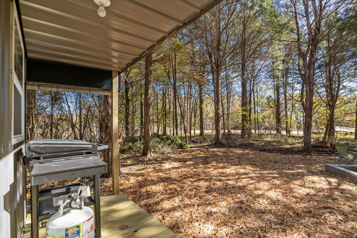 0 Birdsong Road Holladay, TN 38341 - Photo 4 of 47 a backyard of a house with table and chairs