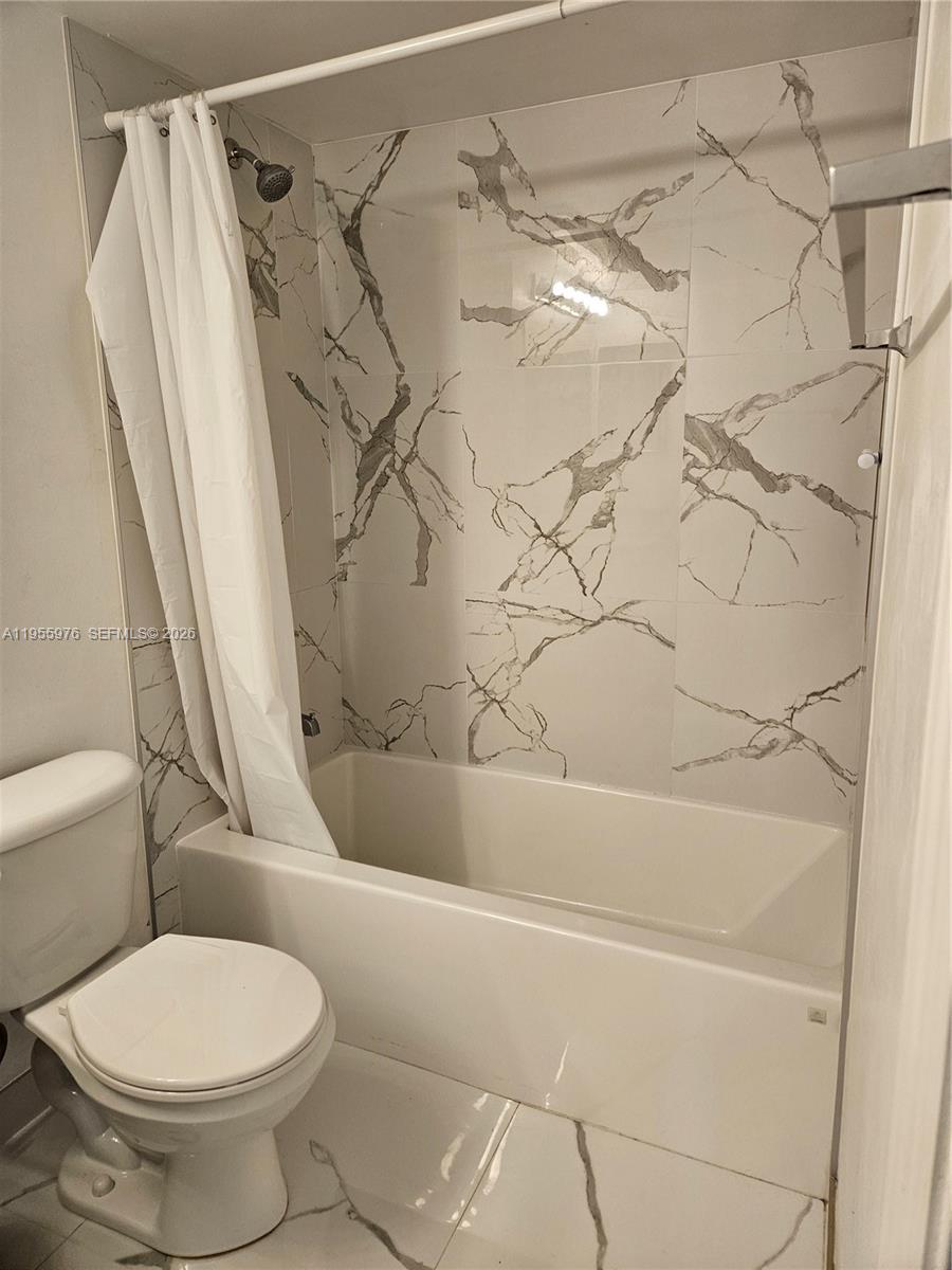 5011 Wiles Road, Unit 306 Coconut Creek, FL 33073 - Photo 10 of 17 a bathroom with a toilet and shower