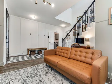 a living room with furniture ceiling fan and rug