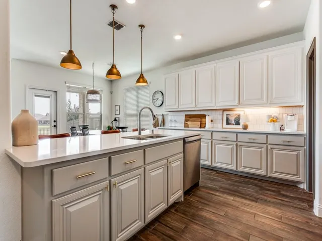 a kitchen with a sink cabinets and window