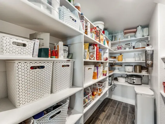 a kitchen with stainless steel appliances granite countertop a sink a stove and a wooden floors