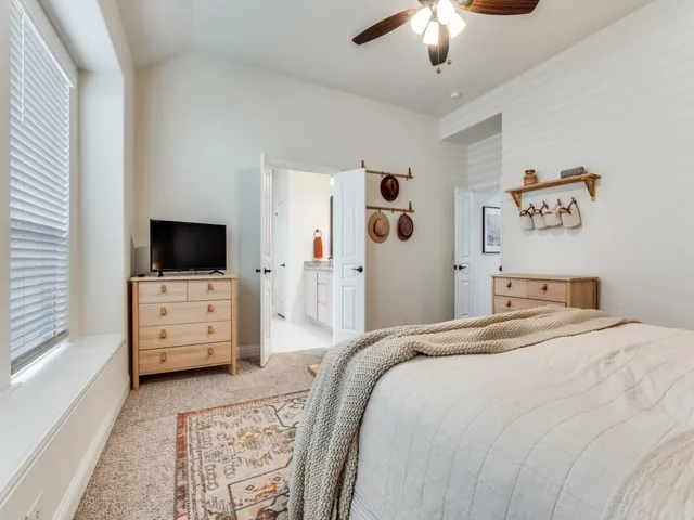 a bedroom with a bed and window