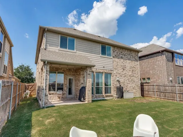 a front view of a house with a yard and a garage