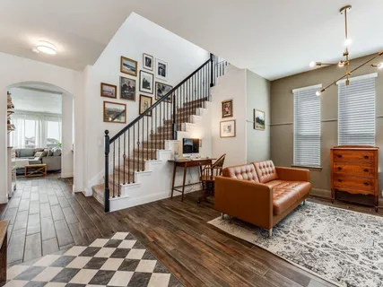 a bedroom with furniture and a rug