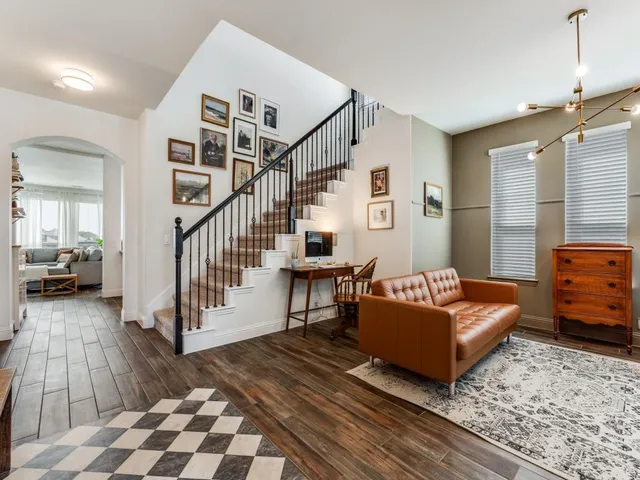 a bedroom with furniture and a rug