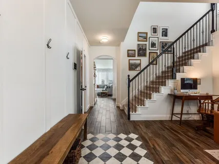 a view of entryway and hall with wooden floor
