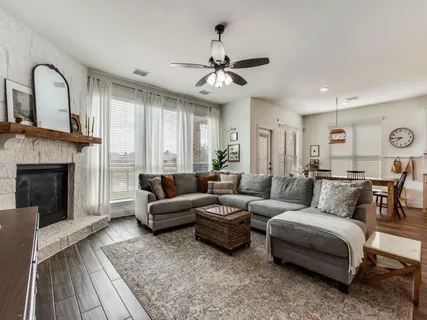 a living room with furniture and a fireplace