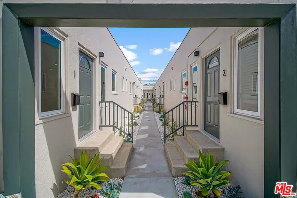 a view of a hallway with flower pots