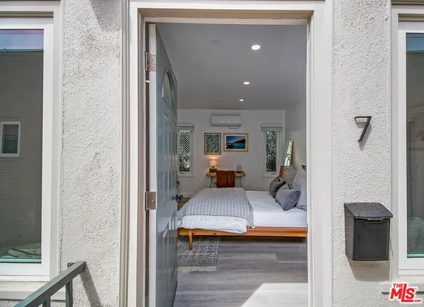 a bedroom with furniture and a window