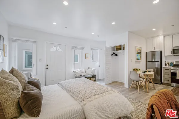 a bedroom with furniture and a closet