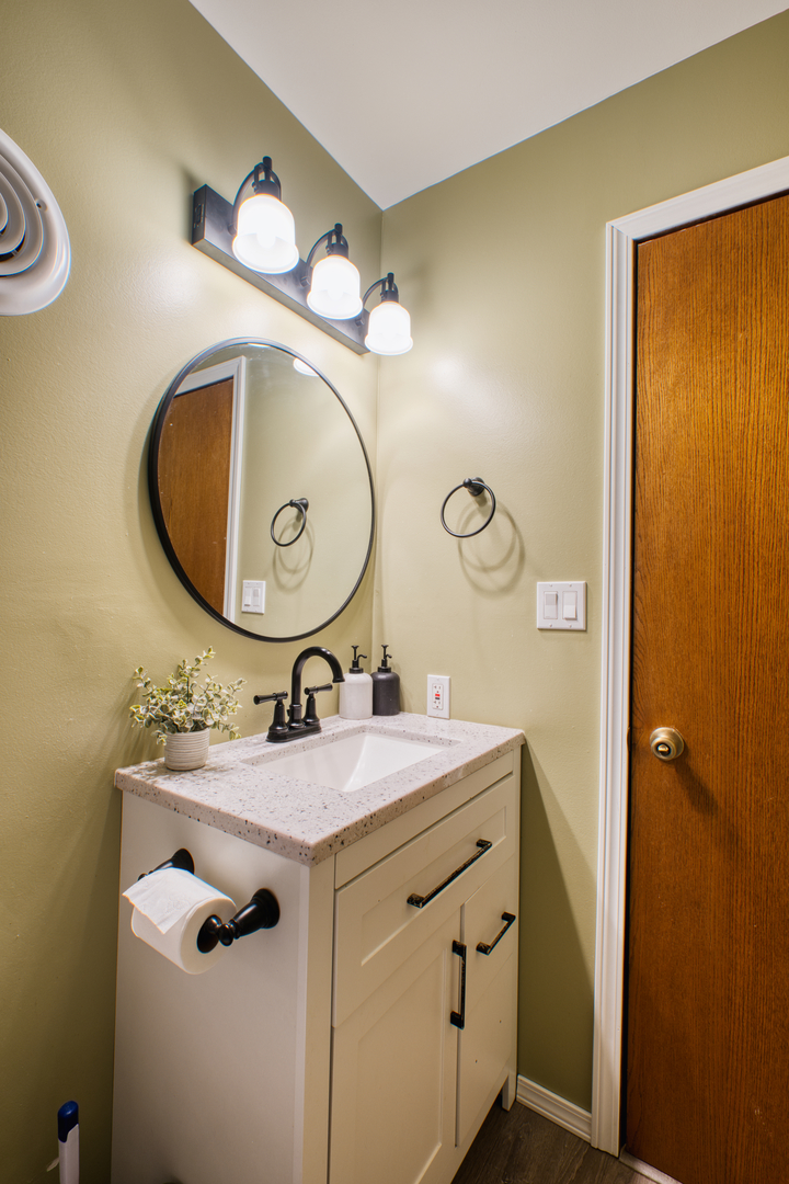 2313 Lafayette Terrace Clinton, IA 52732 - Photo 21 of 39 a bathroom with a sink vanity and a mirror