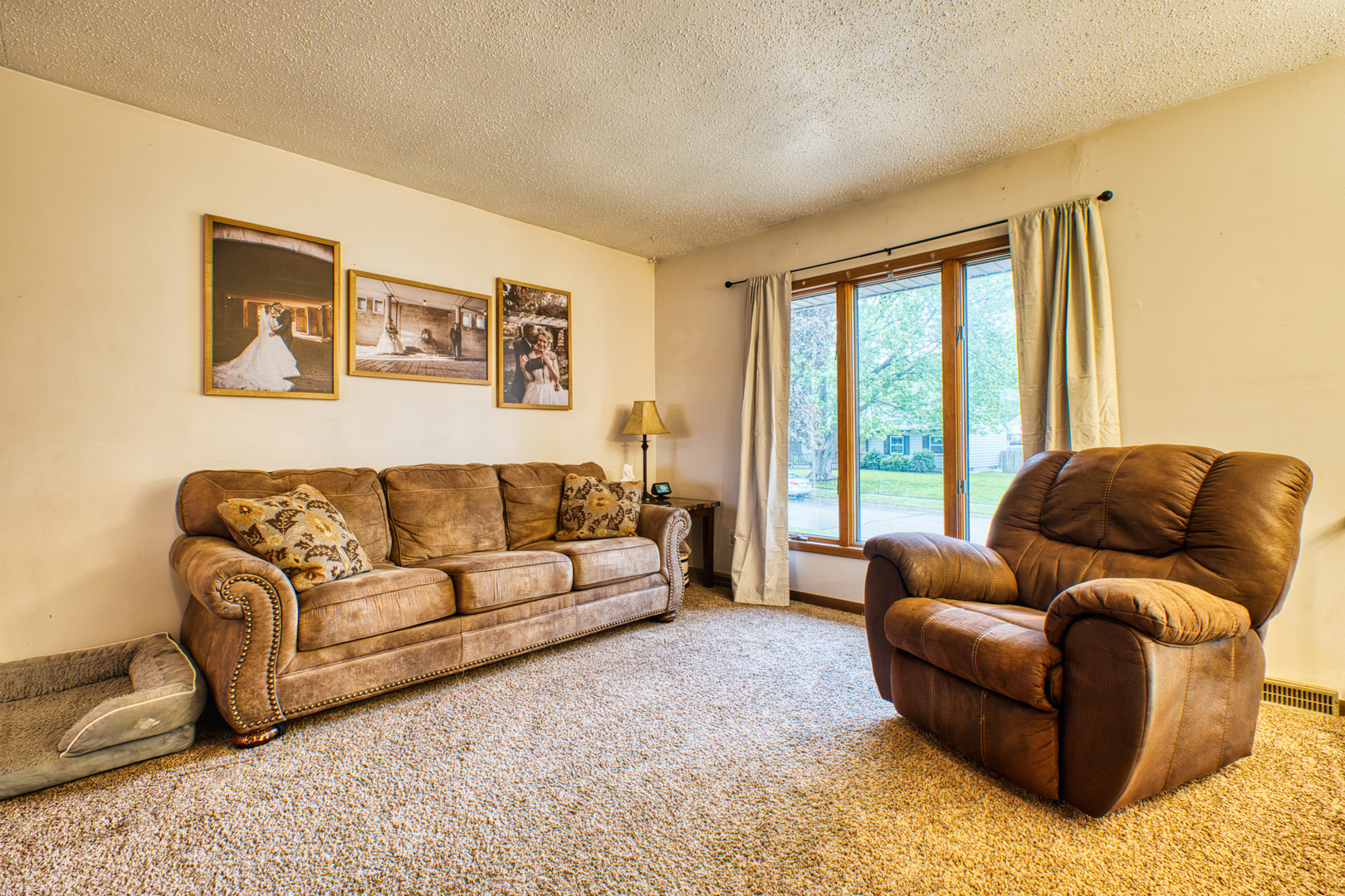2313 Lafayette Terrace Clinton, IA 52732 - Photo 5 of 39 a living room with a couch and a large window