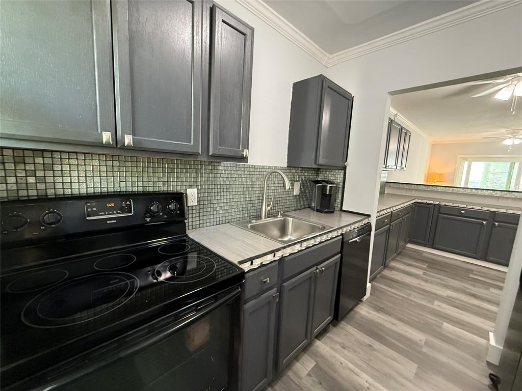2121 Northeast 42nd Court, Unit 103C Lighthouse Point, FL 33064 - Photo 14 of 31 a kitchen with a stove and a sink