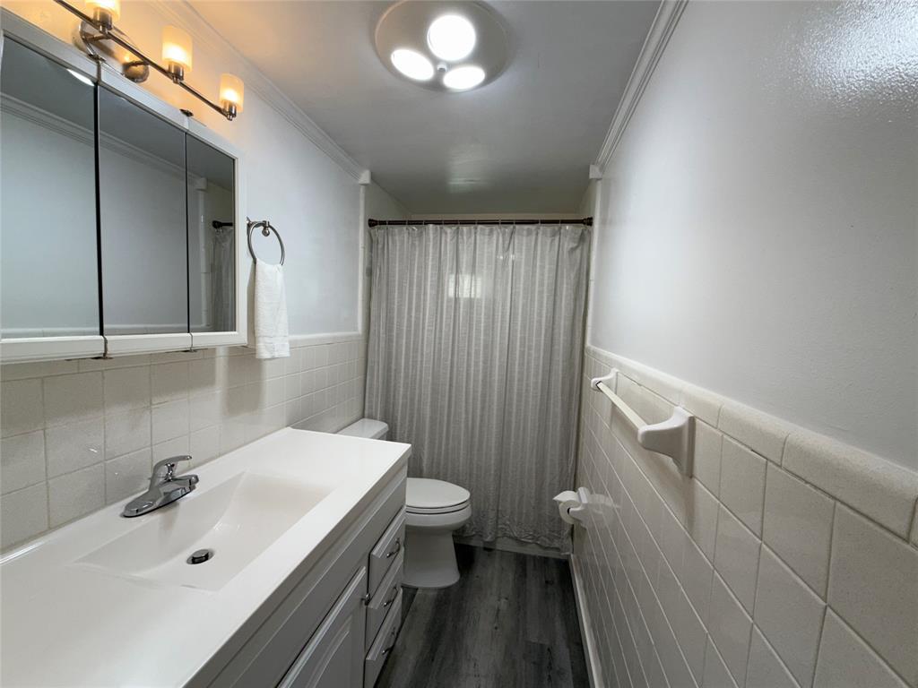 2121 Northeast 42nd Court, Unit 103C Lighthouse Point, FL 33064 - Photo 21 of 31 a bathroom with a sink a toilet and shower