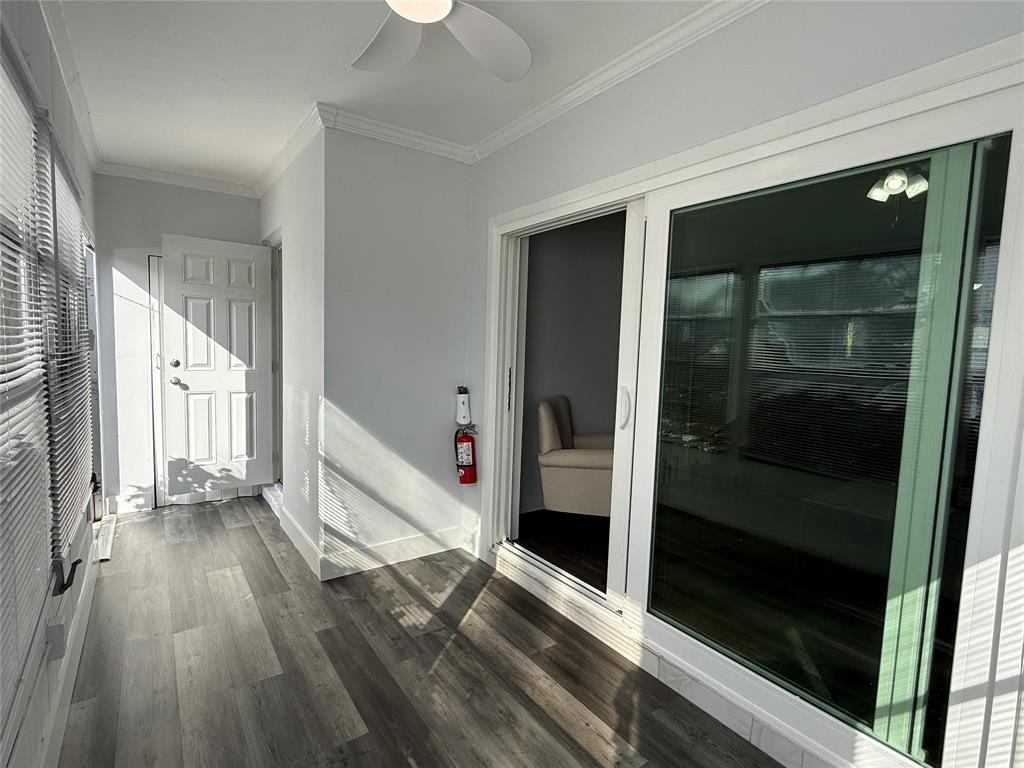 2121 Northeast 42nd Court, Unit 103C Lighthouse Point, FL 33064 - Photo 3 of 31 a view of a hallway with wooden floor and staircase