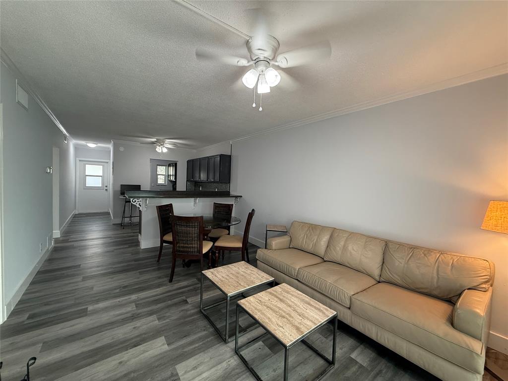 2121 Northeast 42nd Court, Unit 103C Lighthouse Point, FL 33064 - Photo 5 of 31 a living room with furniture and a wooden floor