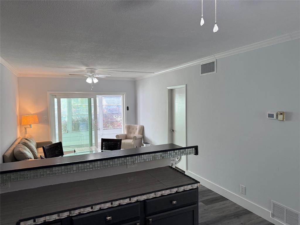 2121 Northeast 42nd Court, Unit 103C Lighthouse Point, FL 33064 - Photo 8 of 31 a kitchen with a sink and large window