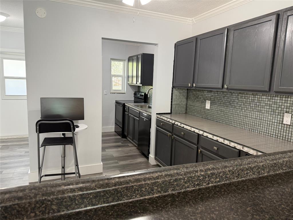 2121 Northeast 42nd Court, Unit 103C Lighthouse Point, FL 33064 - Photo 9 of 31 a kitchen with stainless steel appliances granite countertop a sink stove and microwave