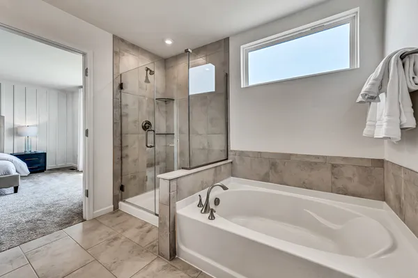 a spacious bathroom with a bathtub and a shower