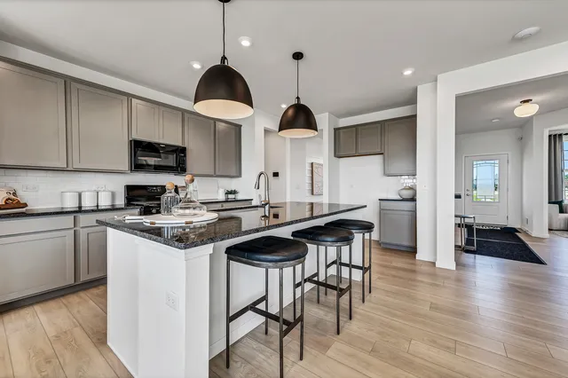 a kitchen with stainless steel appliances a stove a sink and a refrigerator