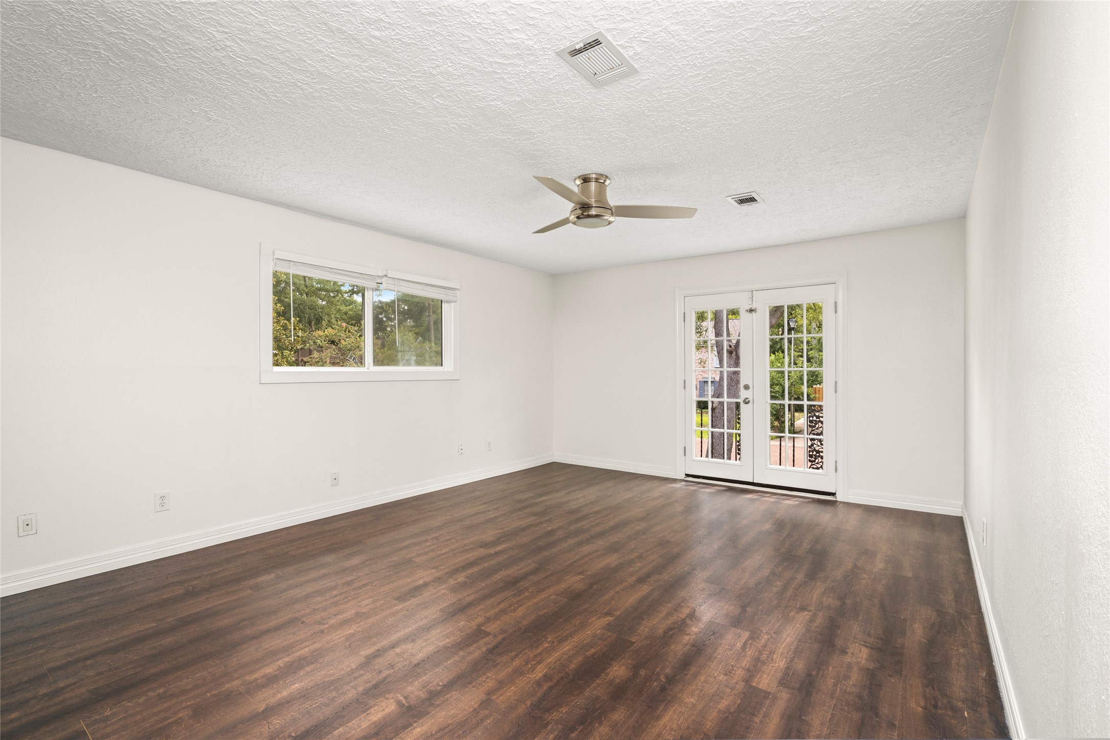 560 Landfall Lane Conroe, TX 77302 - Photo 27 of 41 View of the primary bedroom suite with French doors for extra natural lighting.